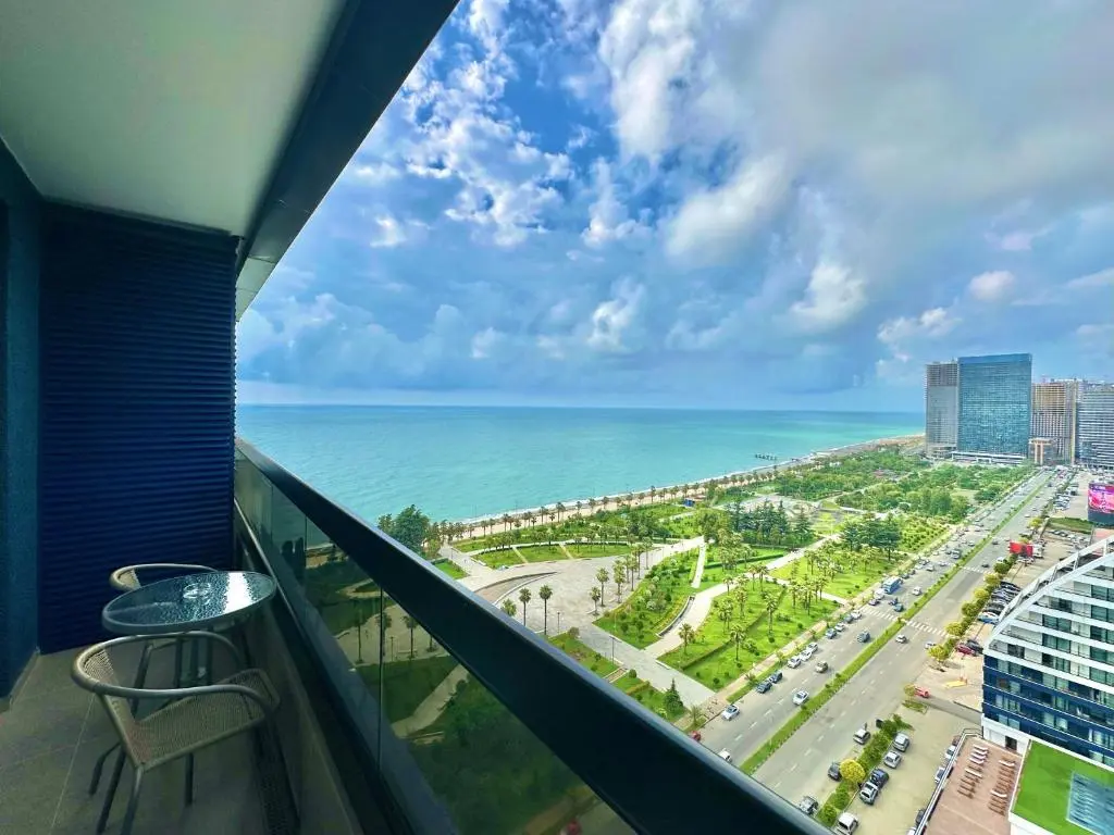 Image of White Sails apartments overlooking the sea, city and park