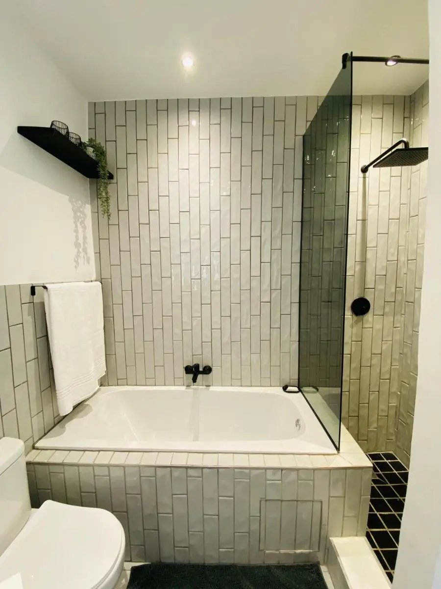 Image 4 of The Monochrome Apartment 209 – Urban Chic Escape – Open Plan Bathroom with Bathtub